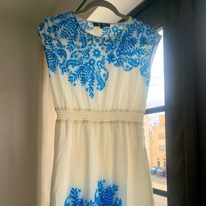 Size S White Dress with blue florals on the top and bottom of the dress.